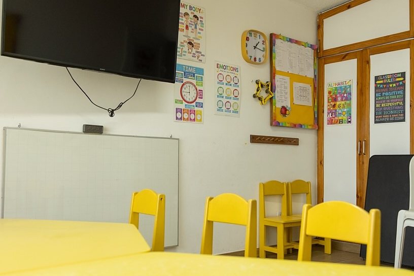 Yellow Class: mesa y sillitas amarillas junto a la pizarra